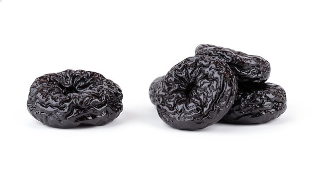 Prunes isolated on white background, heap of dried plums. Dried Fruit / Prunes / Dark Berries
