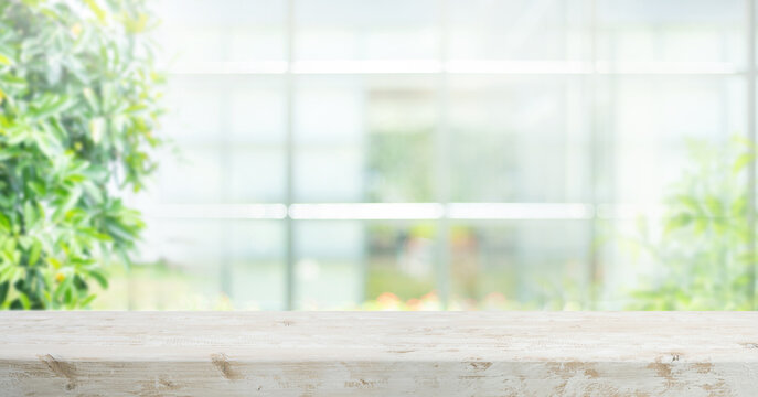 Selective focus.Long banner background with wood table top,counter top with beautiful of blur big glass wall house