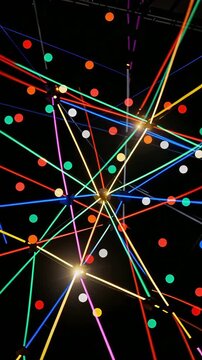 Interweaving colorful laser lines and dots on a black background