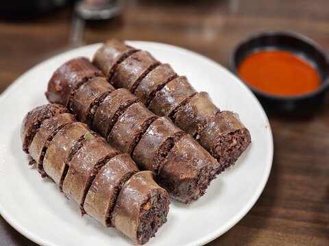 Traditional Korean Blood Sausage (Pisundae) on a White Plate
