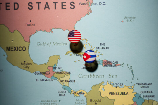 United States and Cuba flags pinned on a world map over the Caribbean, representing geopolitical relations, international diplomacy, and travel routes