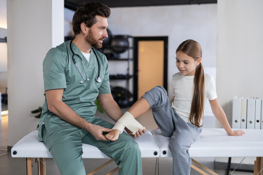 Detail of bandage being applied to child lower leg