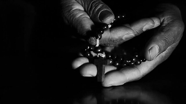 praying to God with hand's together with cross on table with people and black background stock video stock footage