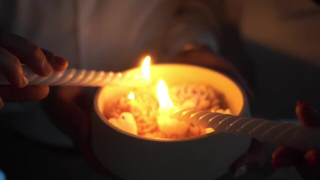 The wedding candle in the hands of the bride and groom. the candle is the family hearth at the wedding. Candle in hand at the wedding