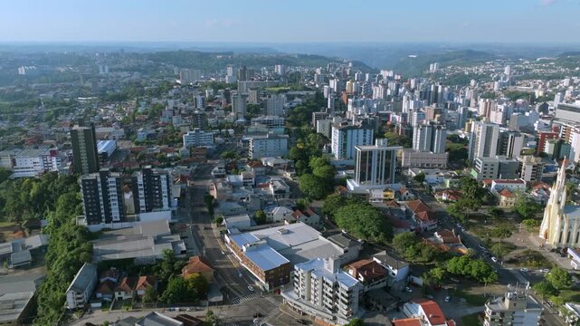 Bento Gon&ccedil;alves cityscape aerial flight over downtown avenues and urban skyline, captured in D-Log with 10-bit color using a Hasselblad sensor.