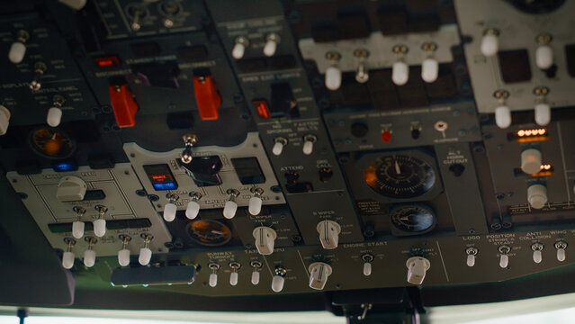 Aircraft dashboard command in empty plane cockpit used to fly with engine throttle and power speed. Control panel buttons and lever fot navigation with radar compass and windscreen. Close up.