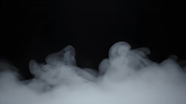 Wisps of white vapor swirl and rise against a dark, black background