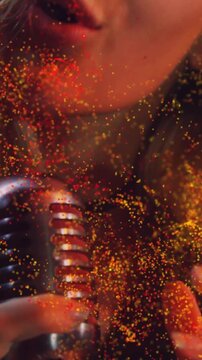Vertical video: Singer opening mouth into retro mic, glitter swelling around lips during music