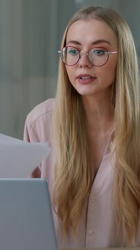 Angry Caucasian business woman talking video call with papers laptop in office stressed businesswoman female leader girl negative conversation conference quarrel discuss documents mistake break report