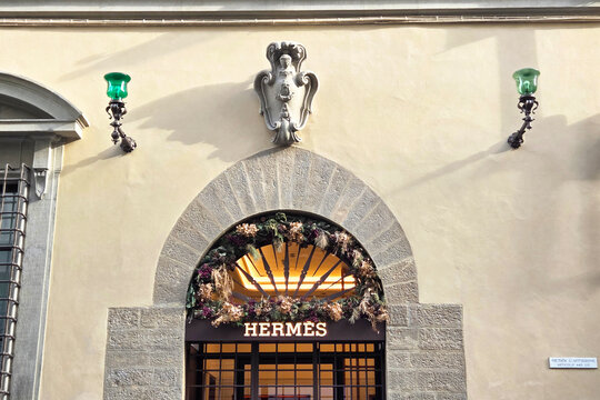 Florence, Italy, January 1, 2026: Luxury Retail Storefront with Stone Arch and Elegant Floral Decorations