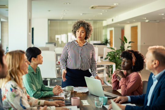 Senior businesswoman leading team meeting in modern office