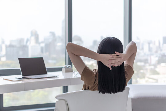 Work -life balance, living quality and carefree mental health concept with young woman take it easy resting in luxury business city hotel or at home office with computer pc laptop on lap