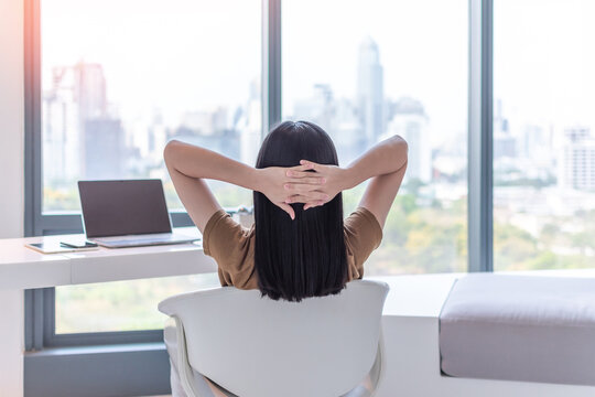 Work -life balance, living quality and carefree mental health concept with young woman take it easy resting in luxury business city hotel or at home office with computer pc laptop on lap