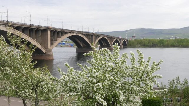 Krasnoyarsk, Russia - May 17, 2025: The Kommunalny Bridge across the Yenisei River. A cloudy spring day.