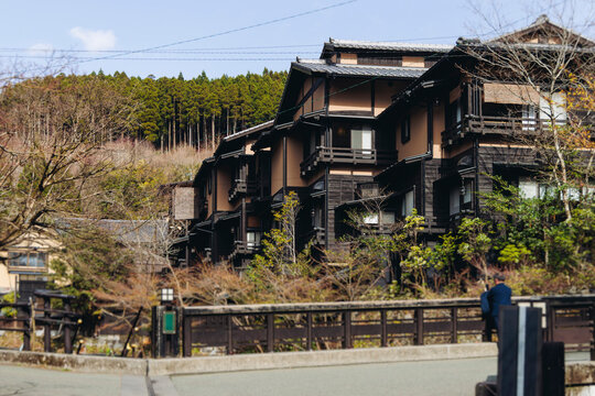Kurokawa Onsen, hot spring resort mountain town, Kumamoto prefecture, Japan, Kyushu island, Minamioguni, Aso District, streets with traditional wooden ryokan public bath houses in a sunny day