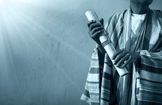Male hand holding an old scroll