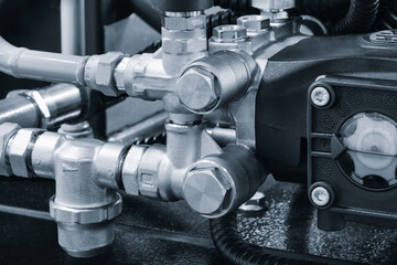 Naklejka na ściany i meble Industrial machine concept, industrial hydraulic machine with rubber and metal pipes high pressure pipes, real technical image.