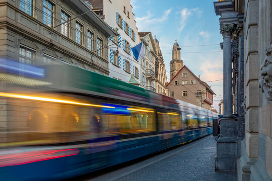 Tram in motion blur in Zurich city street with historic buildings