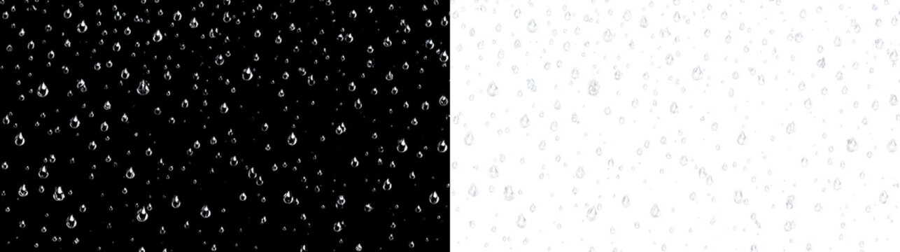 Water droplets fall on a clear surface creating a pattern of various shapes and sizes in a simple setting