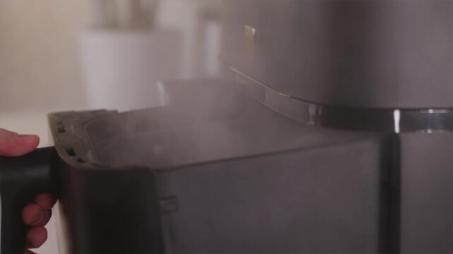 Close up of smoke rising from air fryer after cooking failure