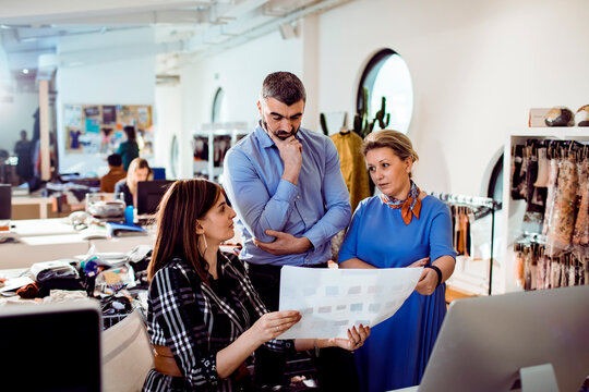 Creative team reviewing color swatches in fashion studio