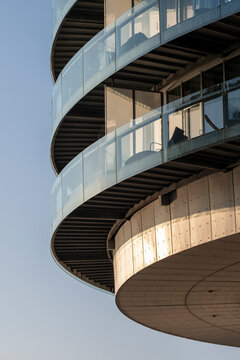 Minimal modern architecture with a curved concrete balcony where clean lines and abstract structure meet open sky in a sleek contemporary exterior detail composition
