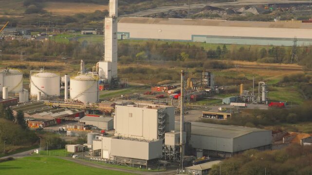 Renewable energy plant converting waste wood to electricity with nearby Industrial gases production and distribution facility providing medical, welding gas. Industry landscape in UK.