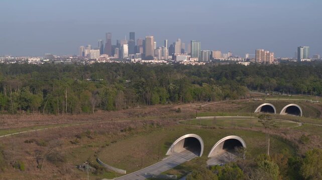 Establishing drone shot of downtown Houston and Memorial city park vast green sparce