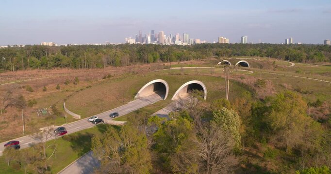 Daytime Drone View of Memorial City Houston Green Space, Walkways, car tunnels and downtown Houston in background