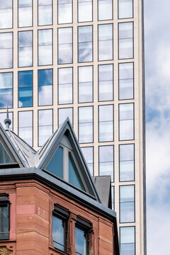 Architecture contrast in Frankfurt Bankenviertel Germany showing historic facade corner against modern skyscraper windows within the skyline