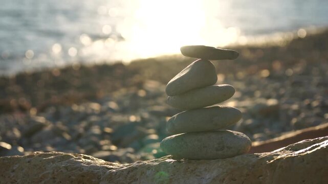 Balanced Stones on a Sunlit Beach