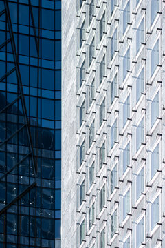 Abstract urban glass facade architecture with blue windows pattern creating modern geometric texture background with clean lines