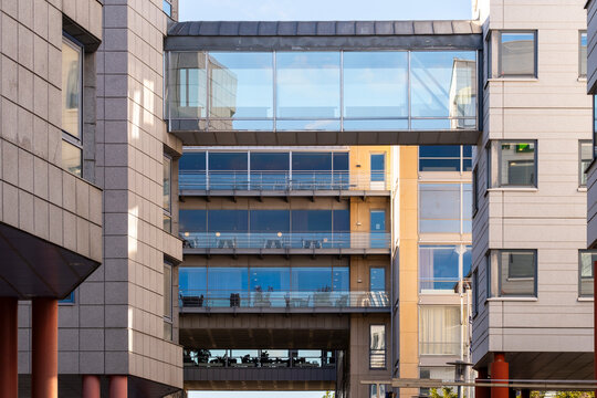 Urban modern office building architecture featuring glass windows and a skybridge corridor creating strong perspective for abstract design background