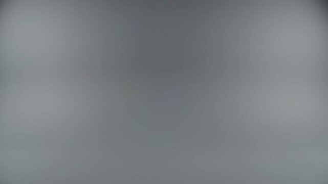 A clean minimalist grey studio backdrop glows in a neutral commercial photography space ideal for product and packshot presentation.