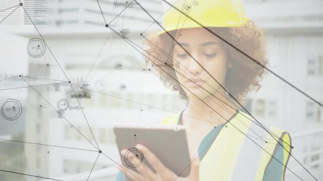 Construction engineer scrolling tablet on rooftop creating AR overlay for site monitoring