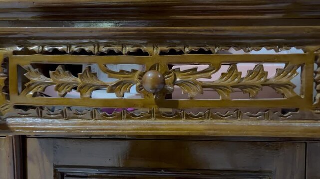 Close-up of hand opening and closing a wooden drawer.