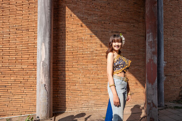 Naklejka premium Beautiful young women wear Contemporary Thai dresses with jeans as a fashion trend in Chiang Mai.