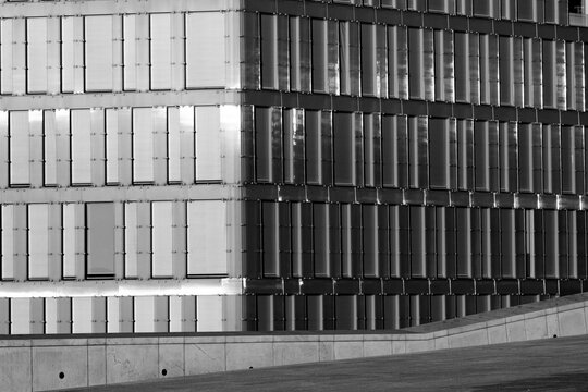 Monochrome modern architecture facade with windows pattern repetition grid in concrete showing minimalism and clean urban design lines