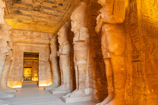 Inside abu simbel temple, large statues of pharaohs define the ancient egyptian architecture, showcasing a rich cultural heritage