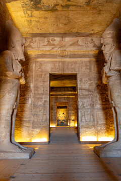 Abu simbel temple's interior view showing towering pharaoh statues, detailed hieroglyphs, and reliefs illuminating ancient egyptian heritage