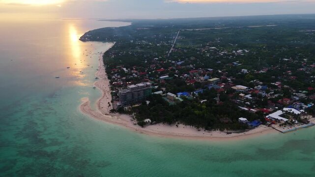 aerial drone panorama of Bantayan Island, Philippines, during a golden sunset, featuring a vibrant sky and calm ocean