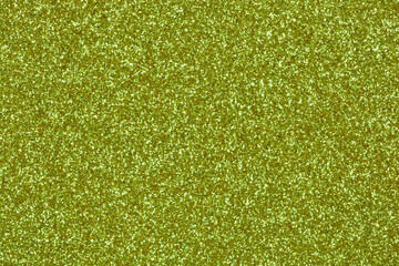 Obraz premium A dense shimmering light green glitter background with a fine sparkling texture and brilliant metallic reflections