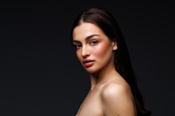 Naklejka premium Woman natural make up healthy skin and hair dark background