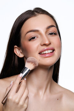 Woman, makeup brush and blush in studio, beauty and grooming products on white background. F
