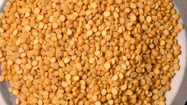 Top View of Chana Dal (Split Chickpeas - Bengal Gram) Rotating on Textured Background &ndash; Food Footage