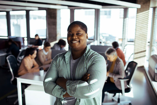 Confident professional with crossed arms in modern office