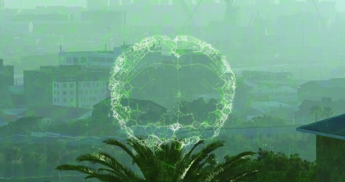 Animation of spinning human brain icon against aerial view of tall buildings