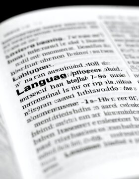 Close-up of a dictionary page, highlighting the word "Language