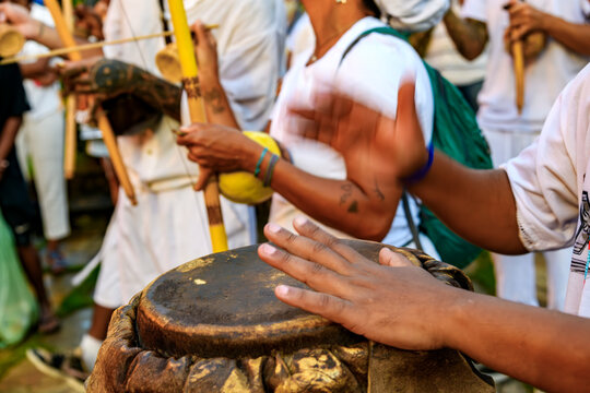 Atabaques and berimbaus during a capoeira performance in the street.