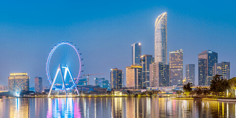 Night view of the Ferris wheel over Jinji Lake and the city skyline in Suzhou, Jiangsu Province, China © Govan